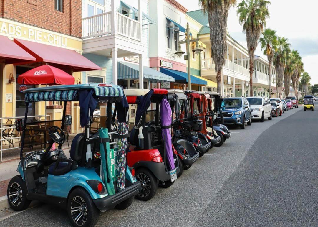 Golf carts lined up on a street in the Villages, Florida